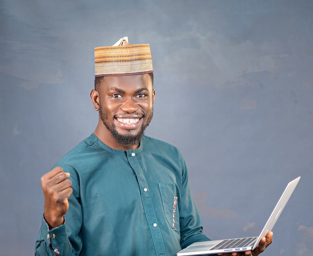A technician holding a repaired laptop